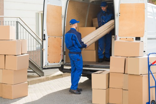 Man with van loading furniture for a move in Fulham