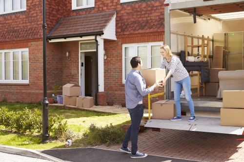 Movers handling furniture and boxes during a Fulham house relocation