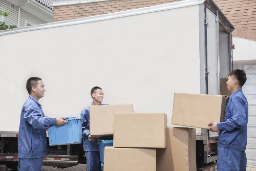 Staff following safe moving practices during a property removal