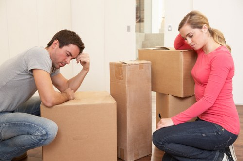 Boxes and furniture being carried from a Fulham apartment building